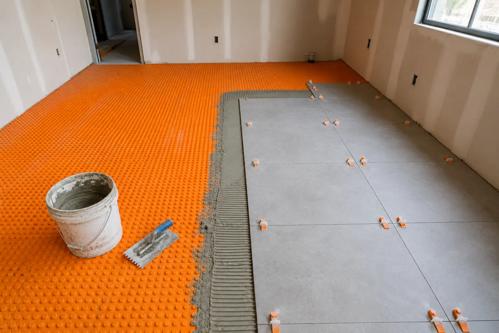 Uncoupling membrane installed over subfloor before tile installation